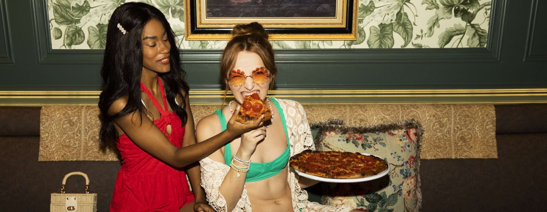 Two women eating pizza